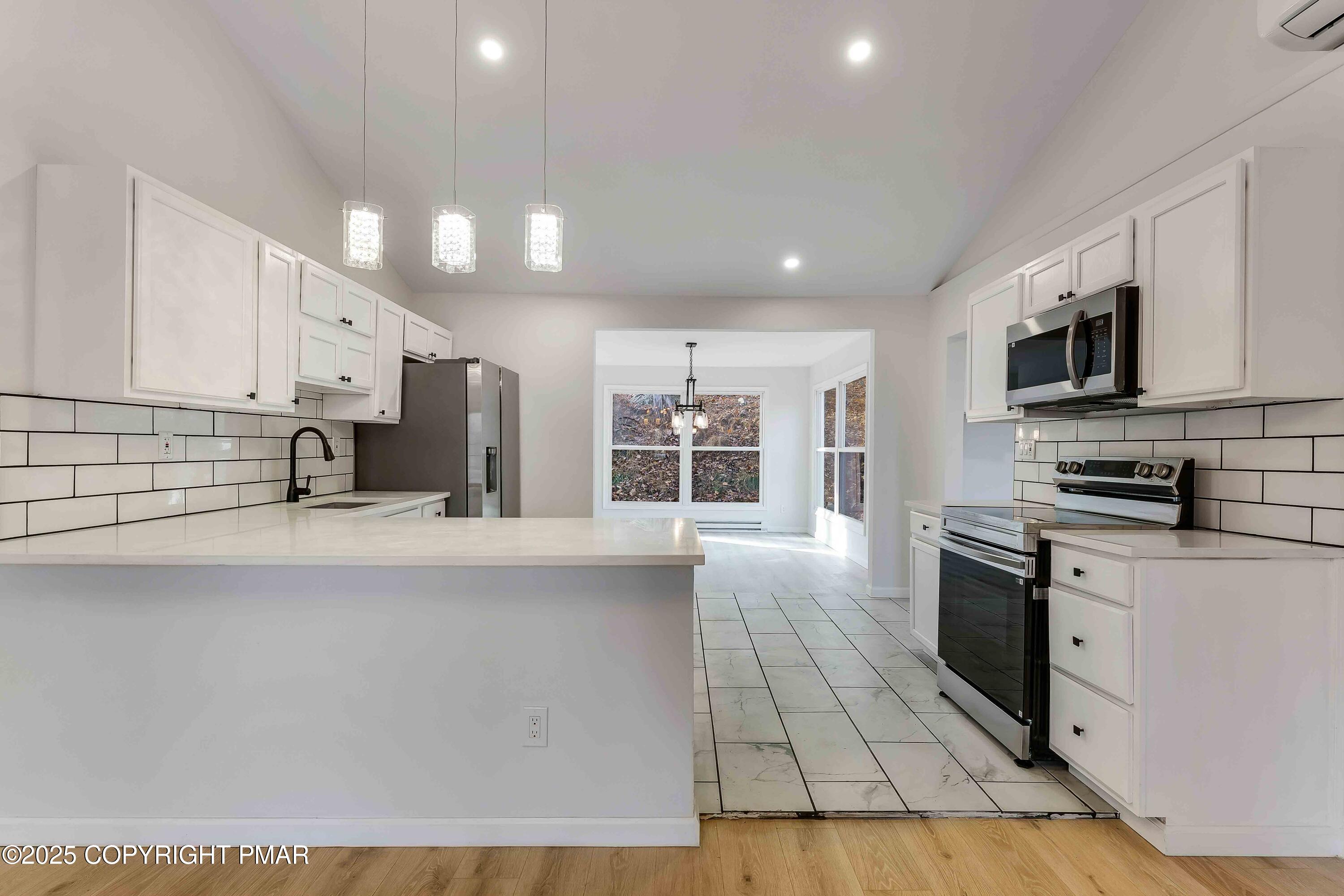 218 Vista Road Cresco, PA 18326 - Photo 18 of 54 a large kitchen with stainless steel appliances and a refrigerator
