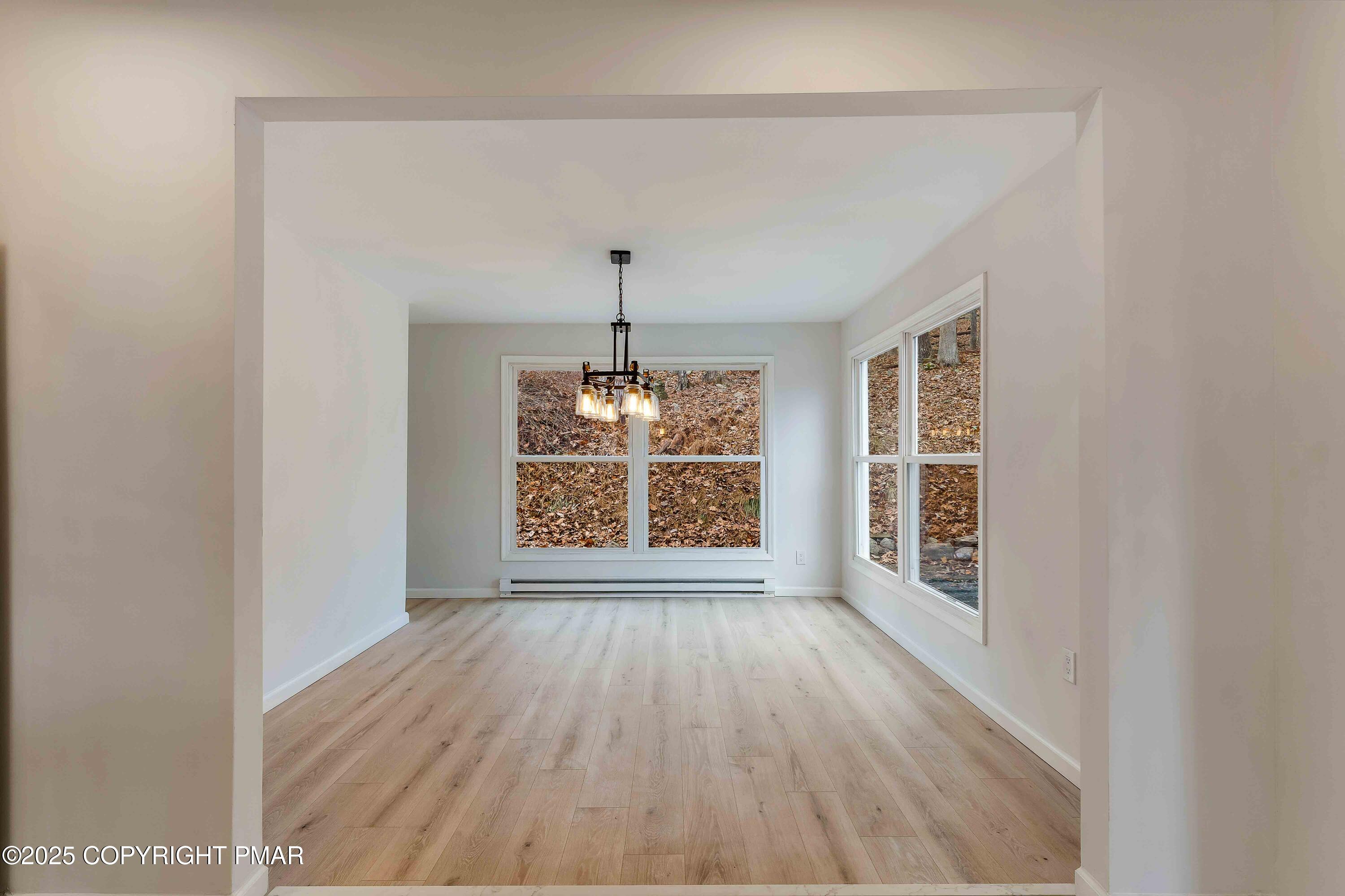 218 Vista Road Cresco, PA 18326 - Photo 27 of 54 a view of an empty room with wooden floor and a window