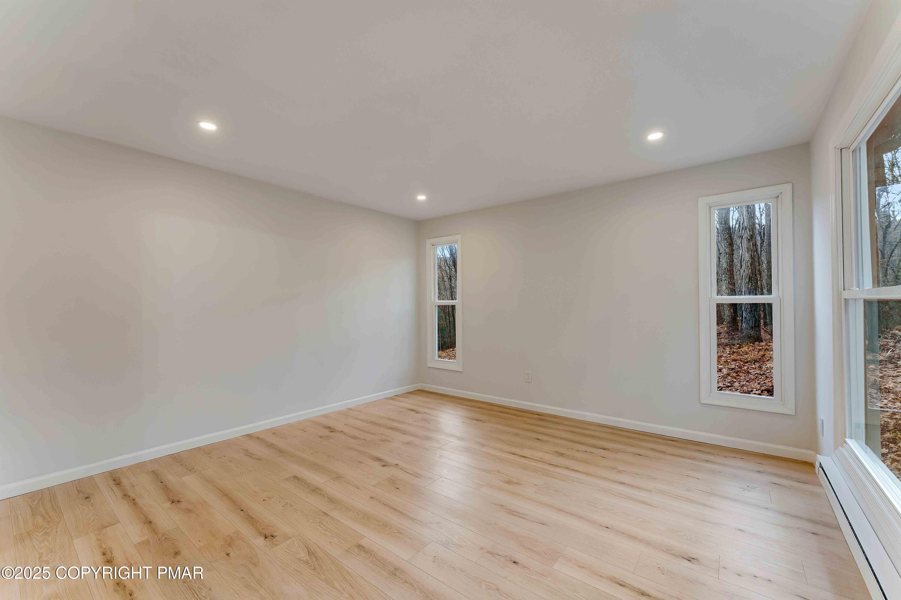 218 Vista Road Cresco, PA 18326 - Photo 32 of 54 an empty room with wooden floor and windows