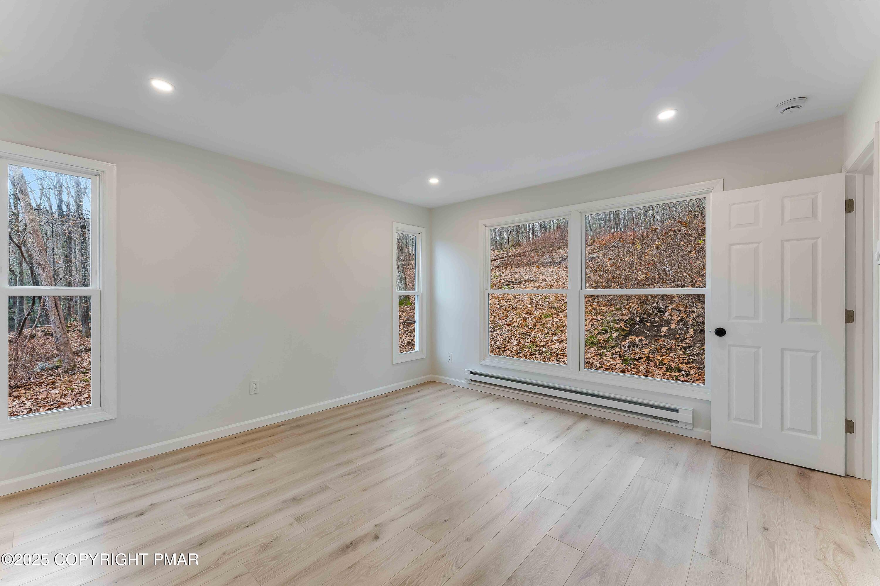218 Vista Road Cresco, PA 18326 - Photo 35 of 54 an empty room with wooden floor and windows
