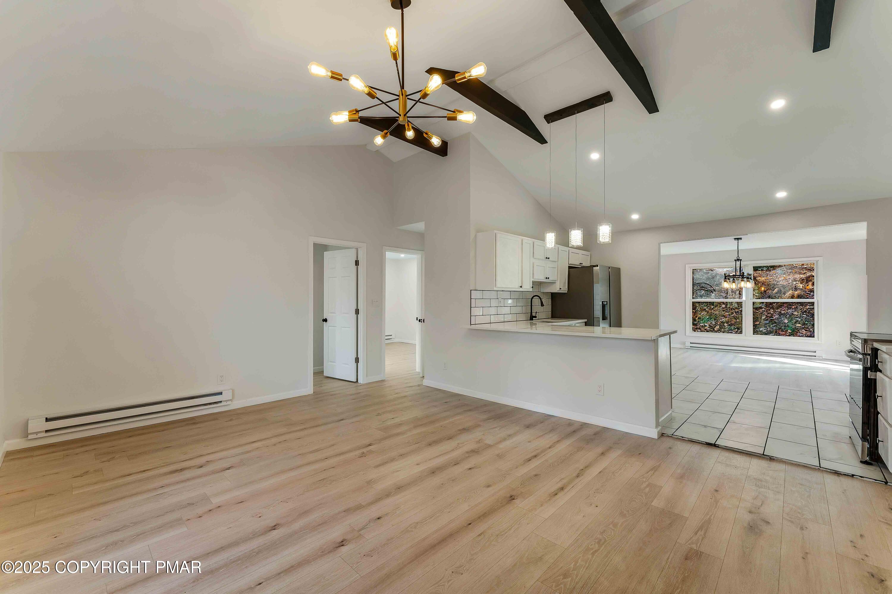 218 Vista Road Cresco, PA 18326 - Photo 4 of 54 a view of an empty room and kitchen view with wooden floor