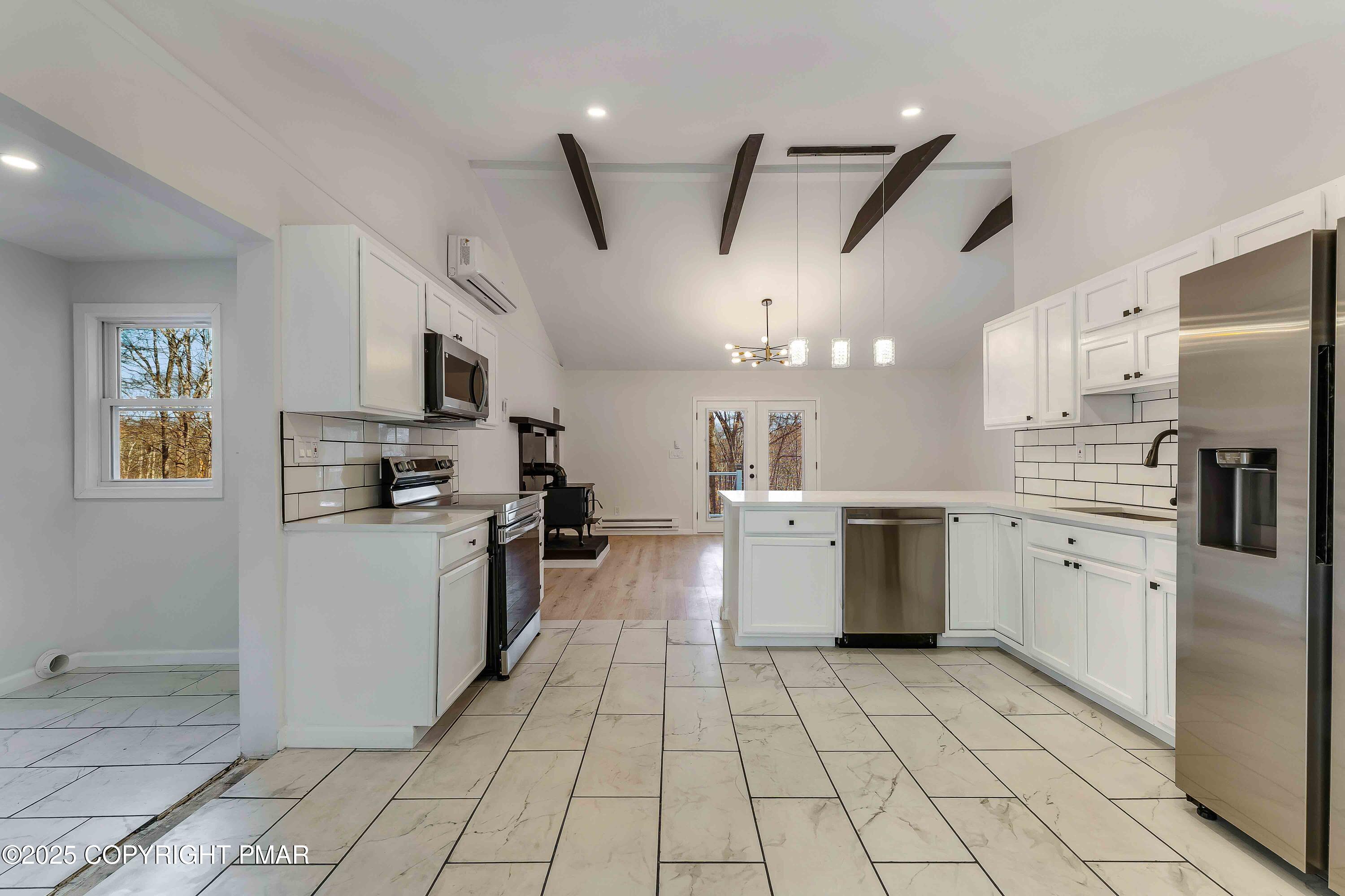218 Vista Road Cresco, PA 18326 - Photo 5 of 54 a large kitchen with a stove a refrigerator a sink dishwasher and a stove top oven