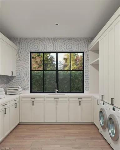 a view of a kitchen with a sink and a washer dryer