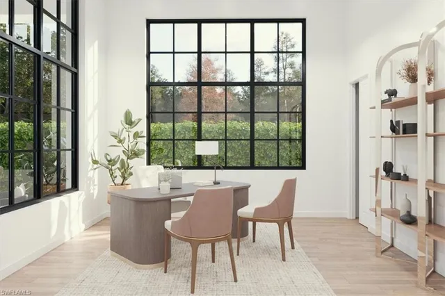 a dining room with furniture and a floor to ceiling window