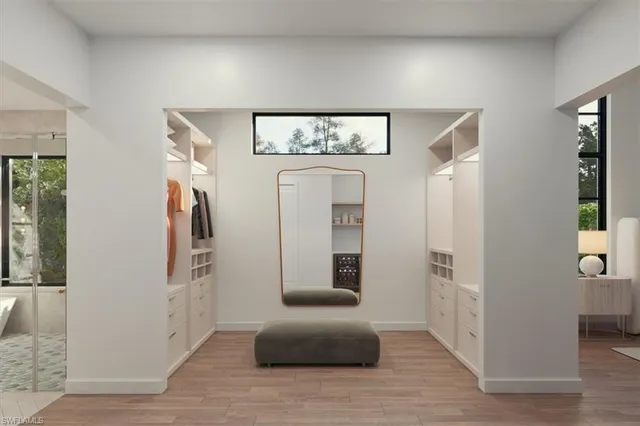 a view of a hallway with windows and entryway