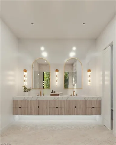 a bathroom with a bathtub a double vanity sink and mirror