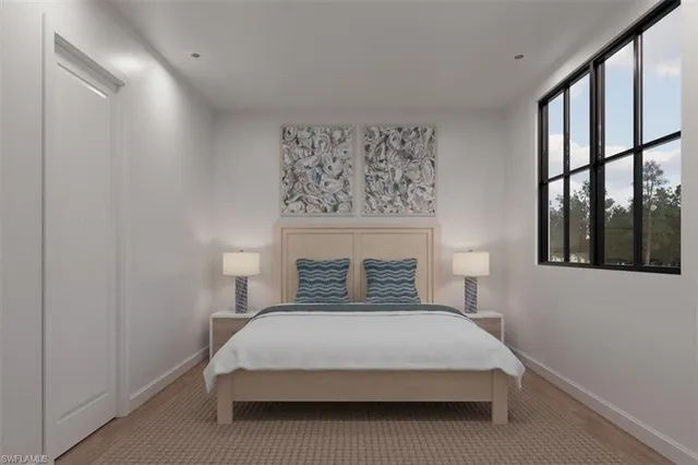 a large bed sitting in a bedroom next to a window