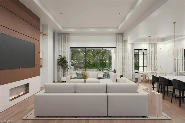 a living room with furniture a large window and a flat screen tv