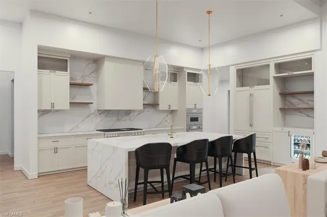 a kitchen with a dining table chairs cabinets and stainless steel appliances