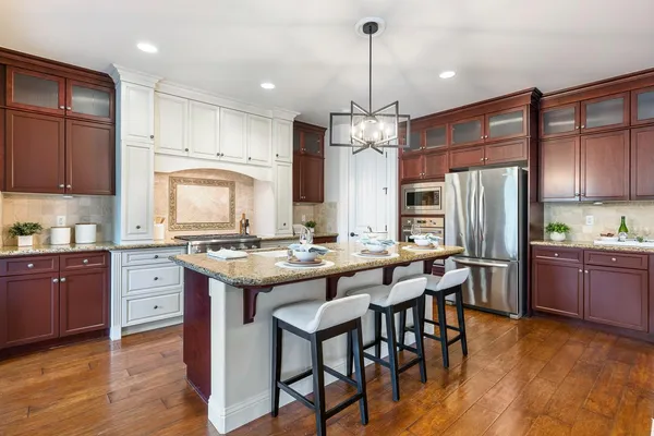 a view of living room kitchen island with furniture and wooden floor