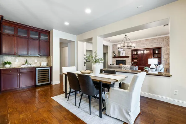 a kitchen with sink stove and chairs