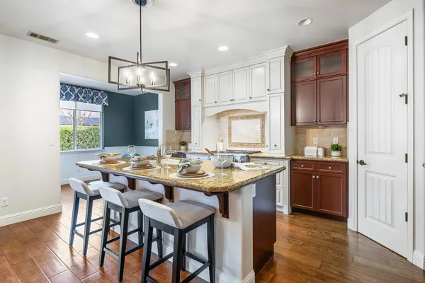 a open kitchen with stainless steel appliances kitchen island granite countertop a sink and cabinets