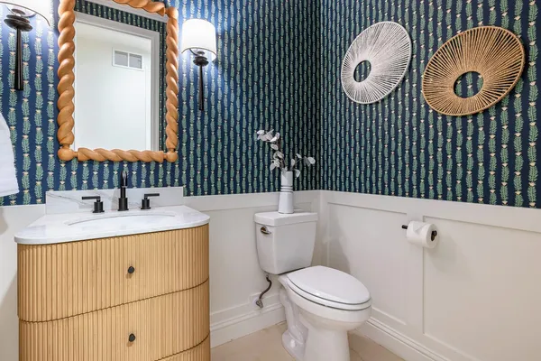 a bedroom with a large bed a chandelier and windows