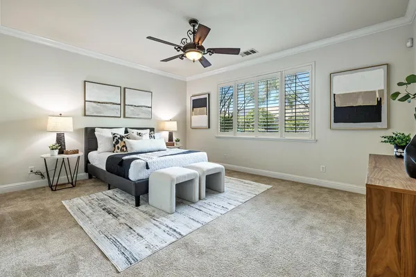 a bedroom with a bed and a chandelier