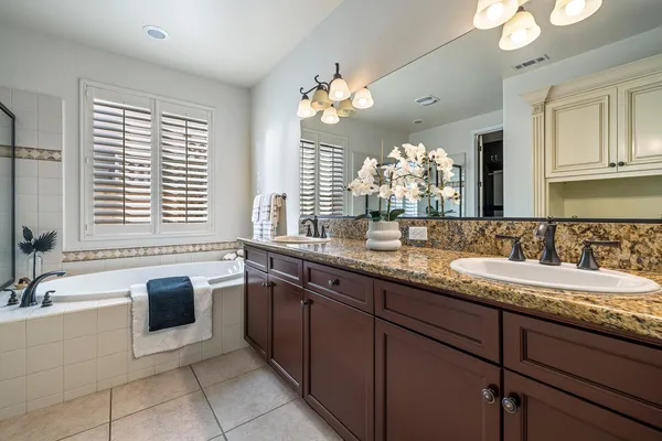 a bathroom with a sink vanity and a mirror