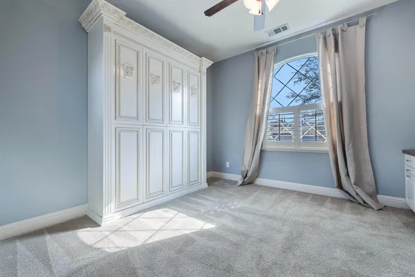 an empty room with windows and closet