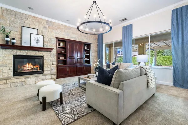 a living room with furniture and a chandelier