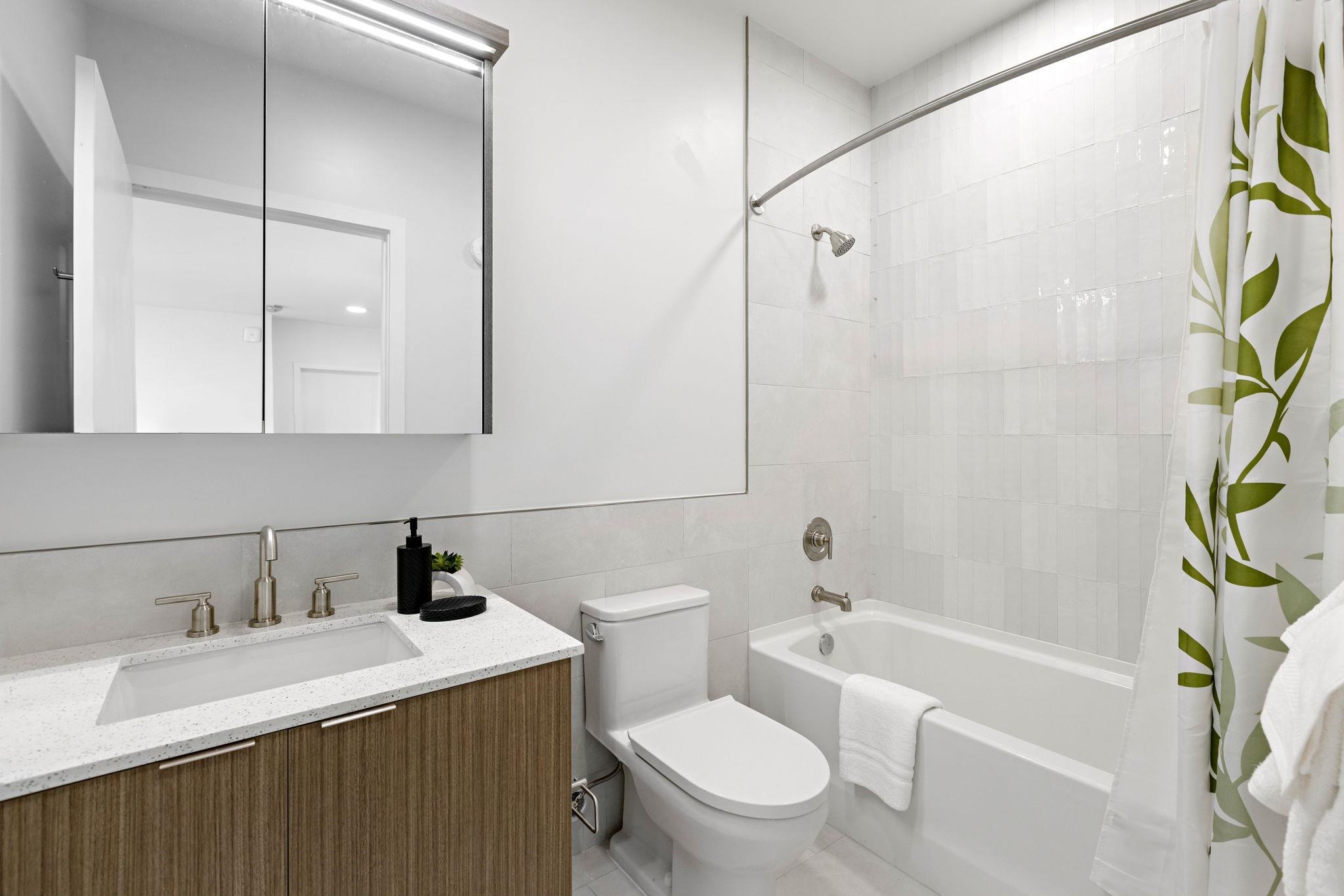 5711 John F. Kennedy Boulevard, Unit 306 North Bergen, NJ 07047 - Photo 20 of 31 a bathroom with a sink a toilet and shower