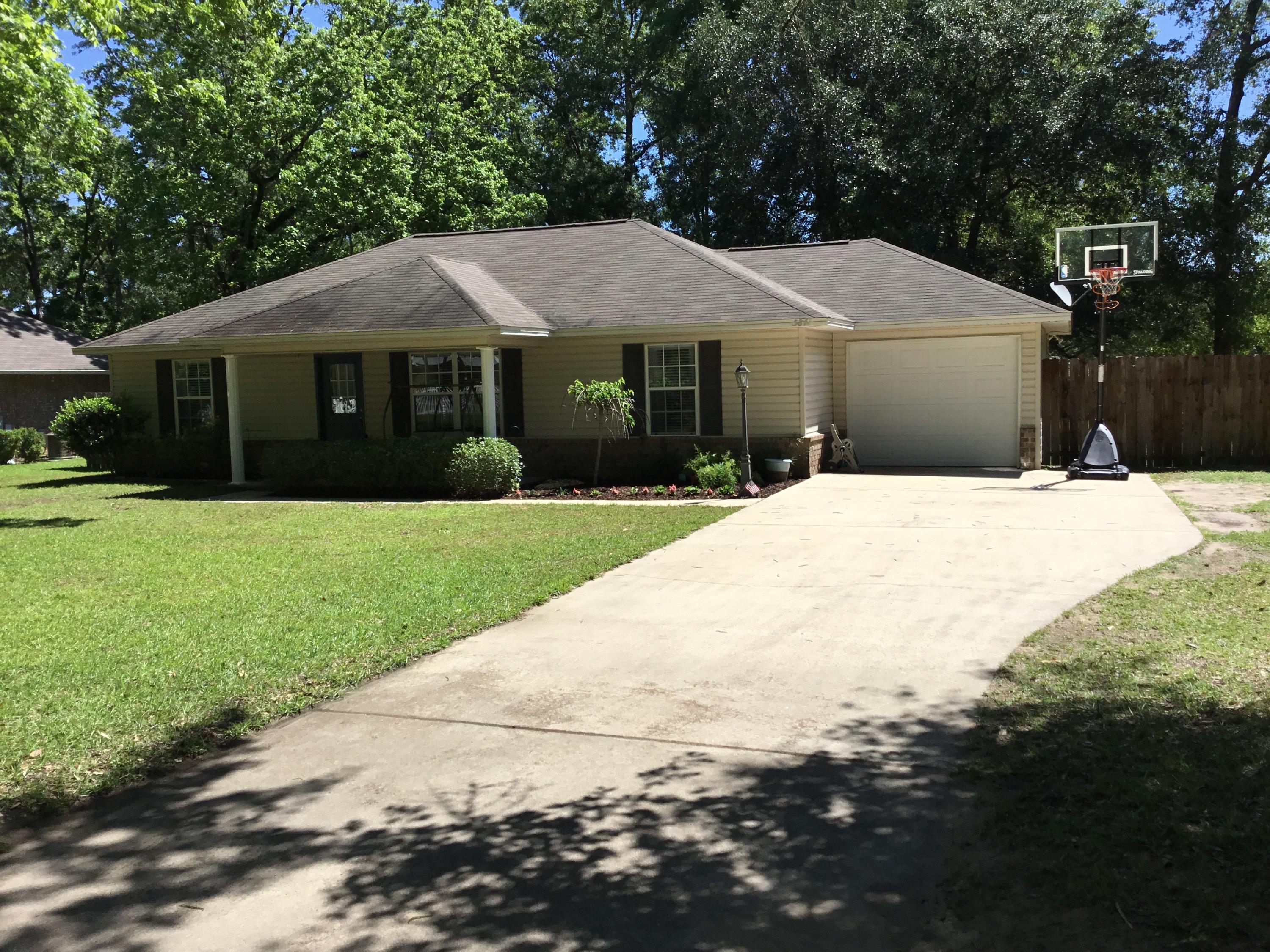 5841 Dairy Road Baker, FL 32531 - Photo 3 of 37 a front view of a house with yard and green space