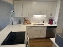 a kitchen with a sink cabinets and a wooden floor
