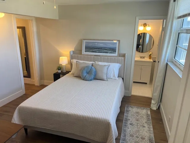 a bedroom with a bed and a mirror