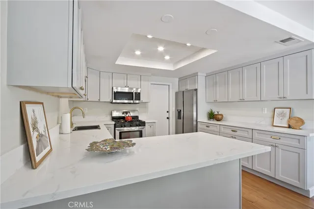 a kitchen with stainless steel appliances a refrigerator sink and cabinets