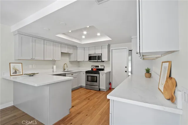 a kitchen with a refrigerator and a sink