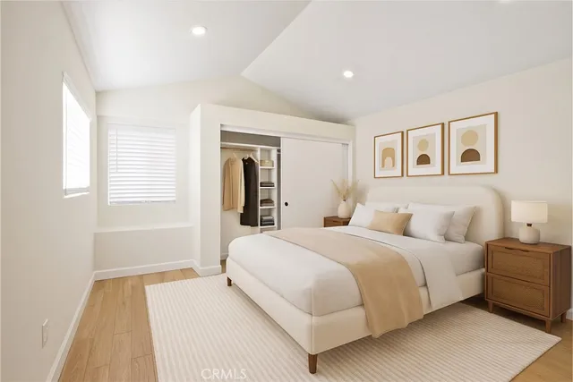 a bedroom with a large bed and a window