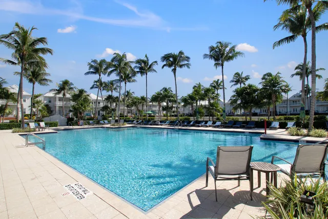 a view of a swimming pool with a table and chairs