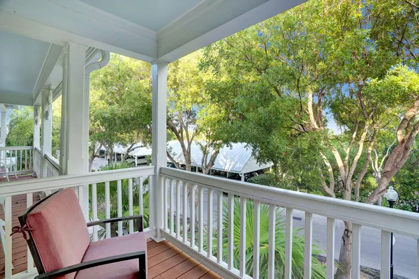 a view of a balcony with wooden floor