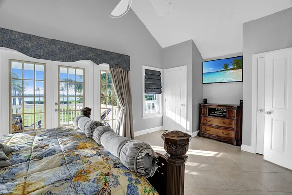 a bedroom with a bed and a large window