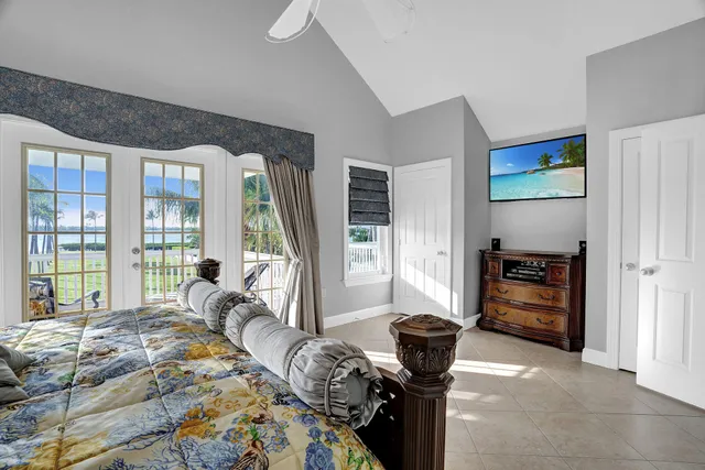 a bedroom with a bed and a large window