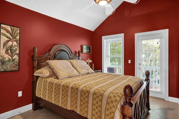 a bedroom with a large bed and a window