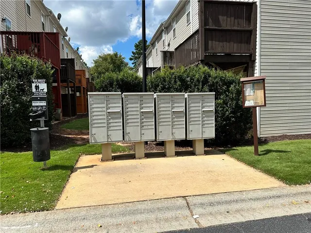 a view of backyard with barbeque grill and wooden fence