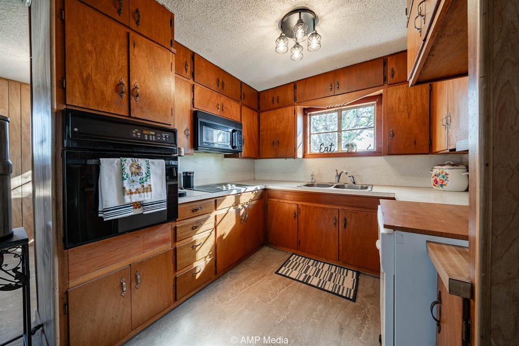 4538 463rd Rule, TX 79548 - Photo 13 of 39 a kitchen with stainless steel appliances granite countertop a sink stove and cabinets