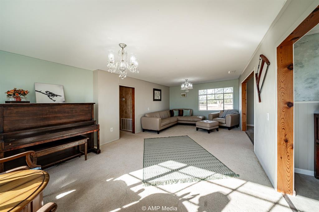 4538 463rd Rule, TX 79548 - Photo 10 of 39 a living room with furniture a chandelier and a window