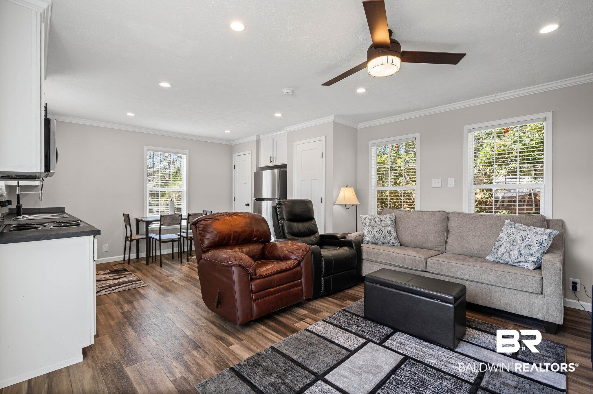 1325 Ridgewood Drive Lillian, AL 36549 - Photo 4 of 32 Living area with dark wood-type flooring, crown molding, ceiling fan, and recessed lighting