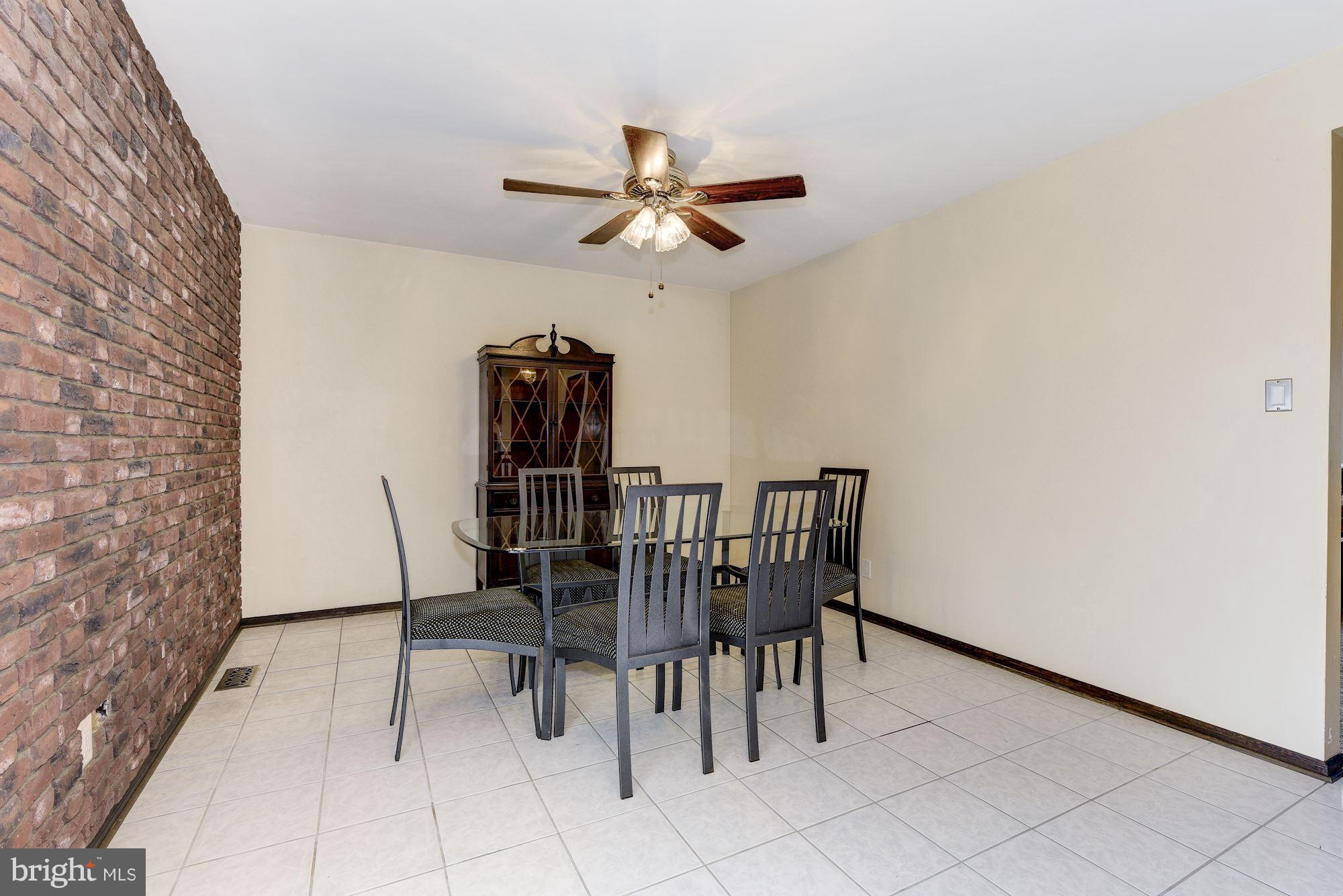 2418 Hopewell Road Marlton, NJ 08053 - Photo 15 of 42 a dining room with furniture and a chandelier fan