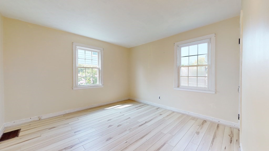 314 Burncoat Street Worcester, MA 01606 - Photo 14 of 29 an empty room with wooden floor and windows