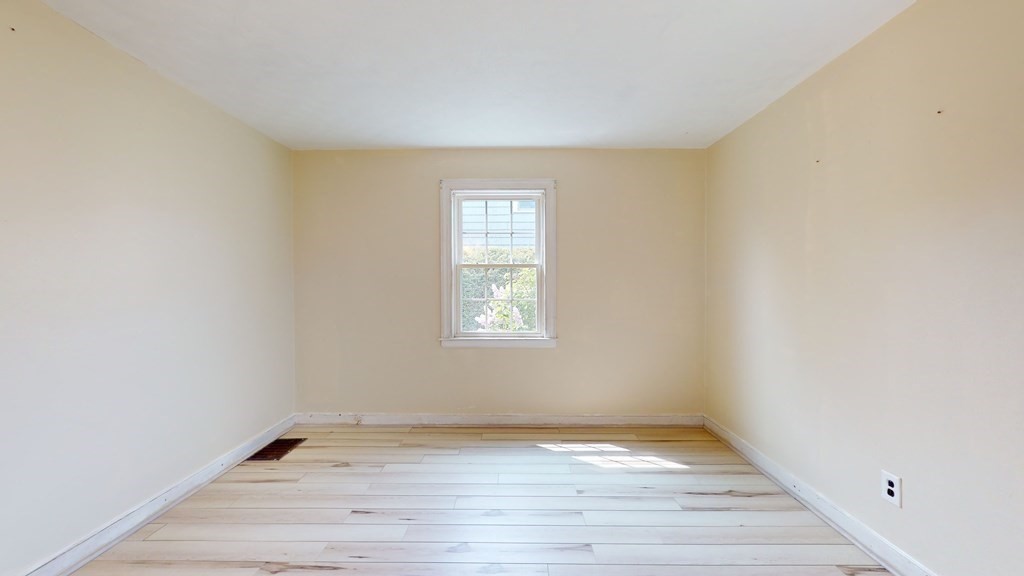 314 Burncoat Street Worcester, MA 01606 - Photo 15 of 29 a view of an empty room with wooden floor and a window