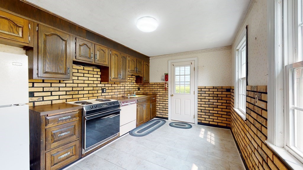 314 Burncoat Street Worcester, MA 01606 - Photo 7 of 29 a kitchen with stainless steel appliances and cabinets