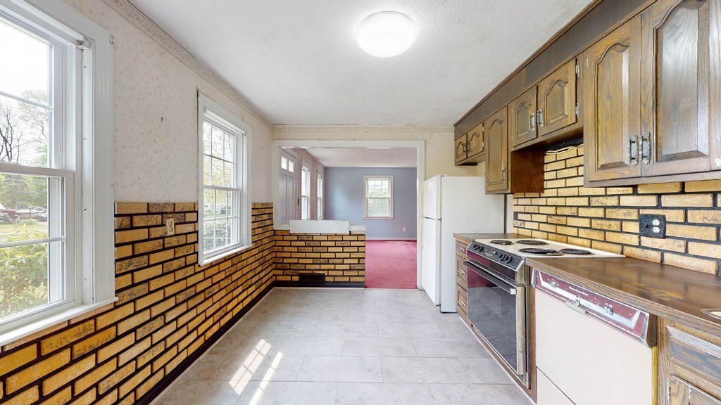 314 Burncoat Street Worcester, MA 01606 - Photo 9 of 29 a kitchen with granite countertop a stove and a sink