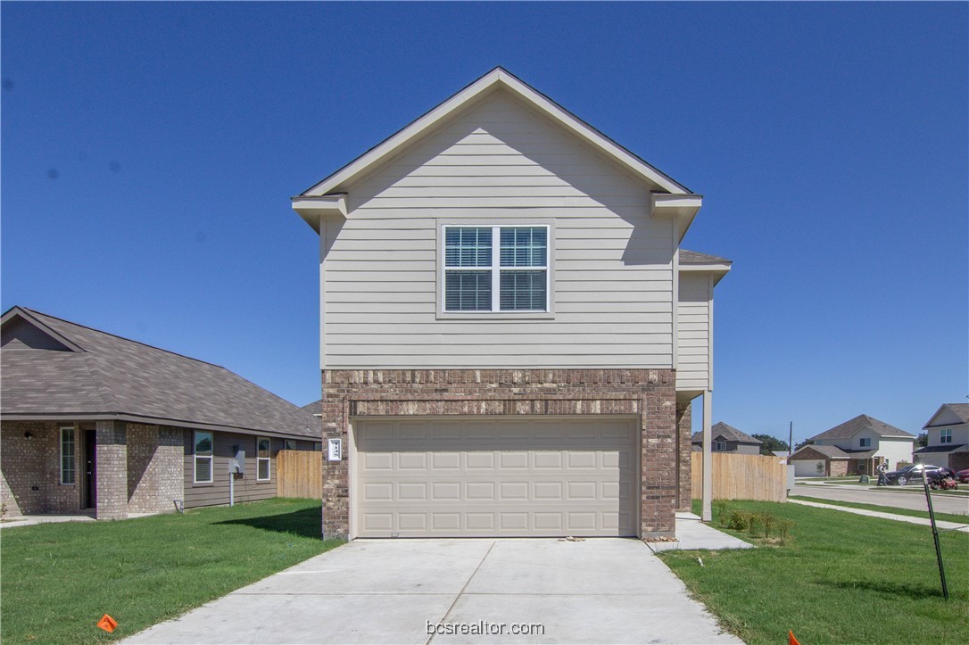 1135 Crossing Drive Bryan, TX 77803 - Photo 1 of 1 a front view of a house with a yard
