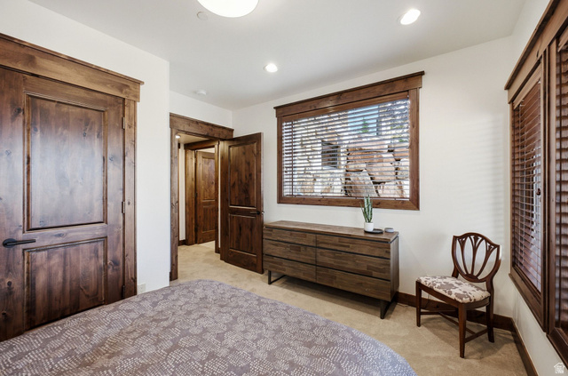 7885 North Rabbitbrush Court, Unit 13 Park City, UT 84098 - Photo 47 of 88 Spacious room featuring wood-finish doors and trim, recessed lighting, and soft carpet flooring
