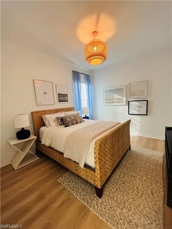 a bedroom with a bed and painting on the wall