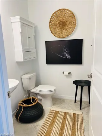 a living room with a toilet and a flat screen tv