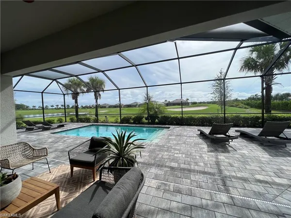 a view of backyard with outdoor seating and plants