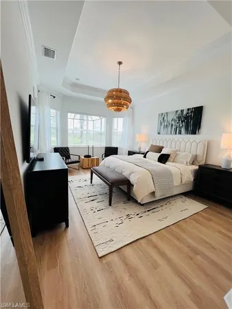 a living room with furniture a fireplace and a chandelier