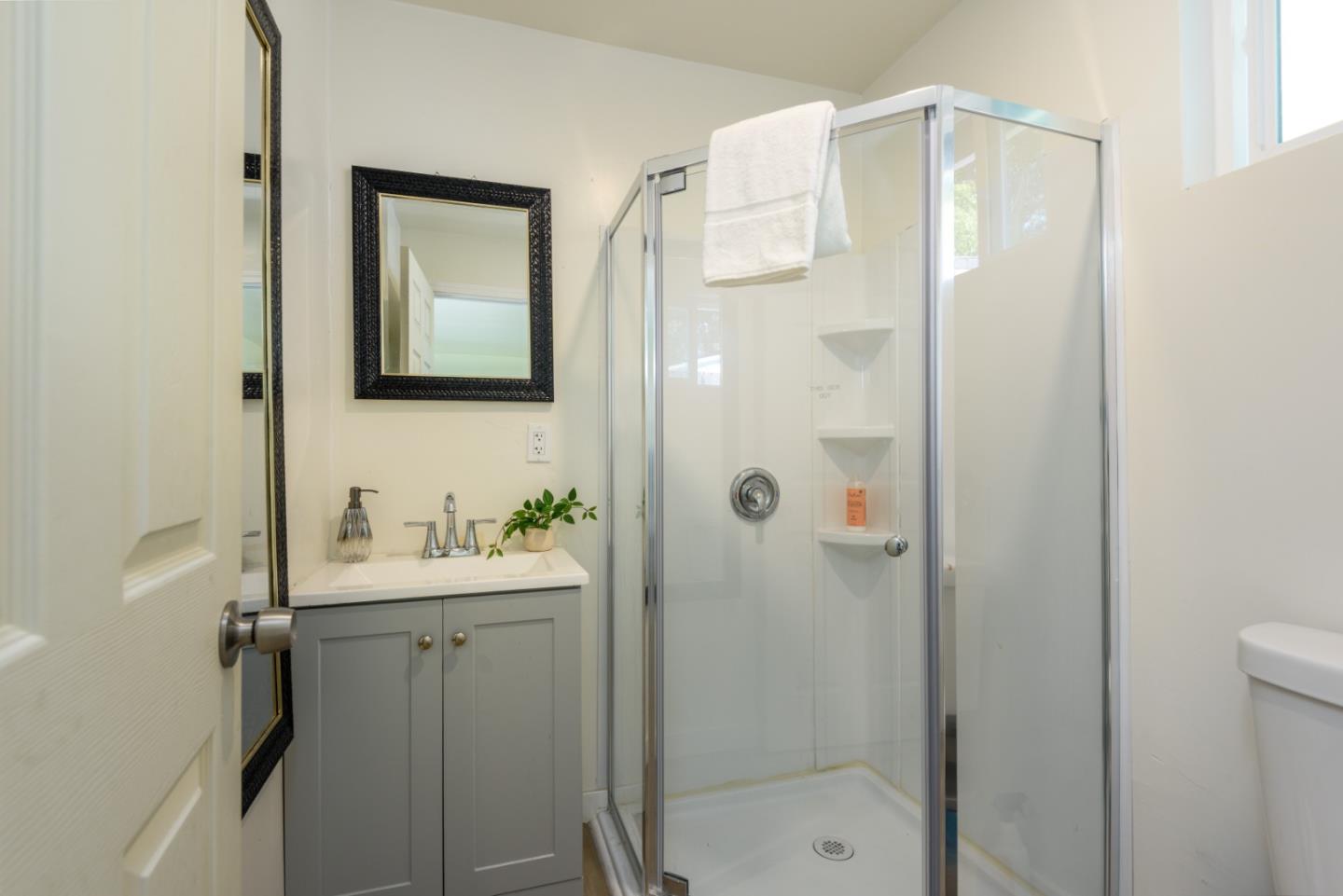 11 Meadow Court San Mateo, CA 94403 - Photo 20 of 31 a bathroom with a shower a sink and a mirror