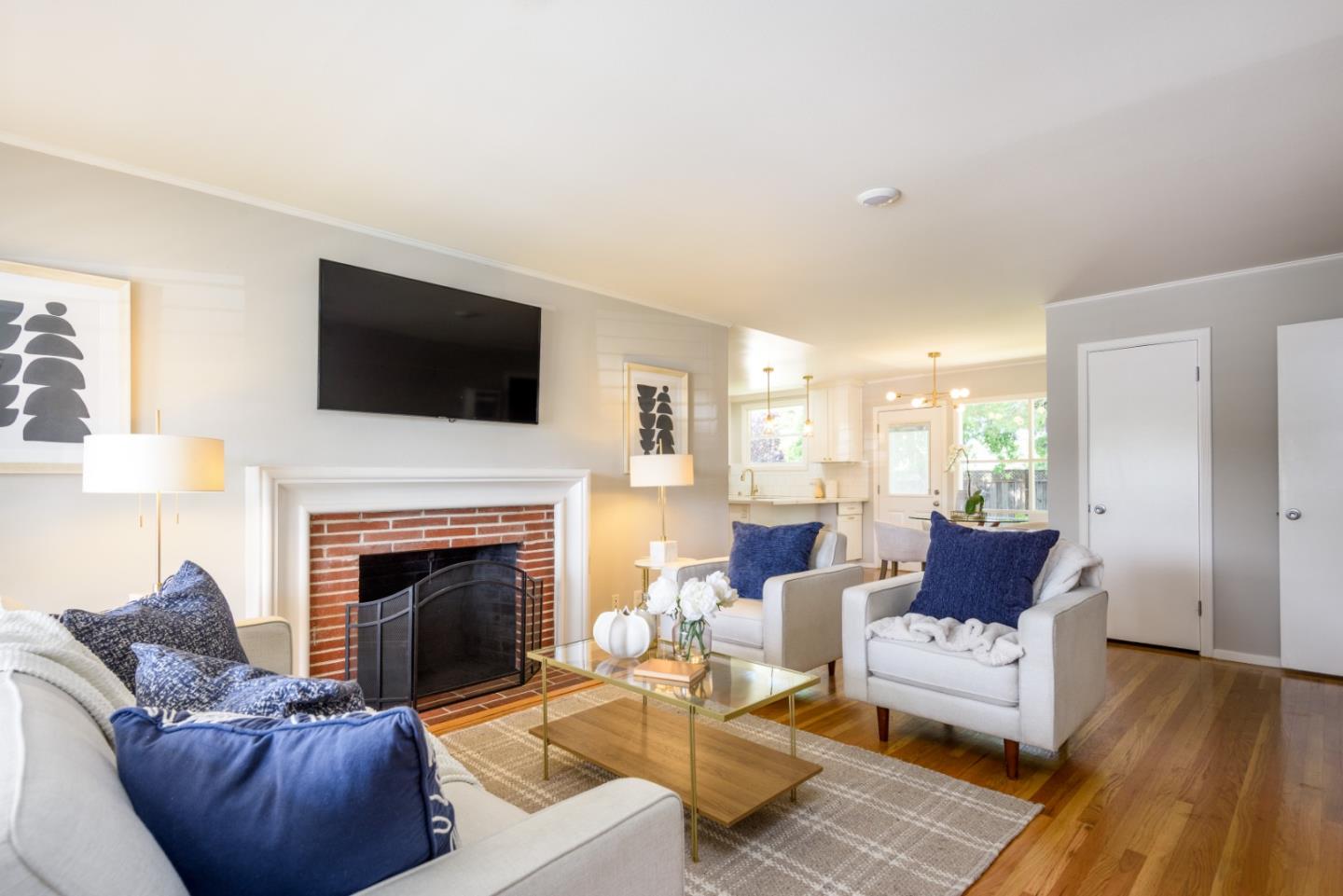 11 Meadow Court San Mateo, CA 94403 - Photo 3 of 31 a living room with furniture a flat screen tv and a fireplace